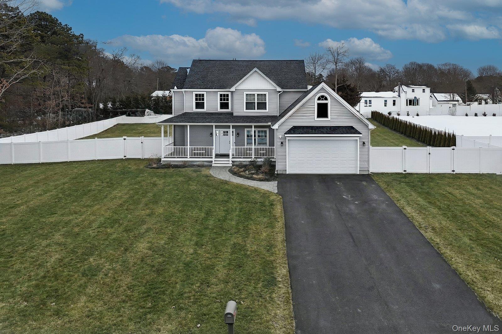 65 Doane Avenue Bellport, NY 11713 - Photo 3 of 37 a front view of a house with a yard
