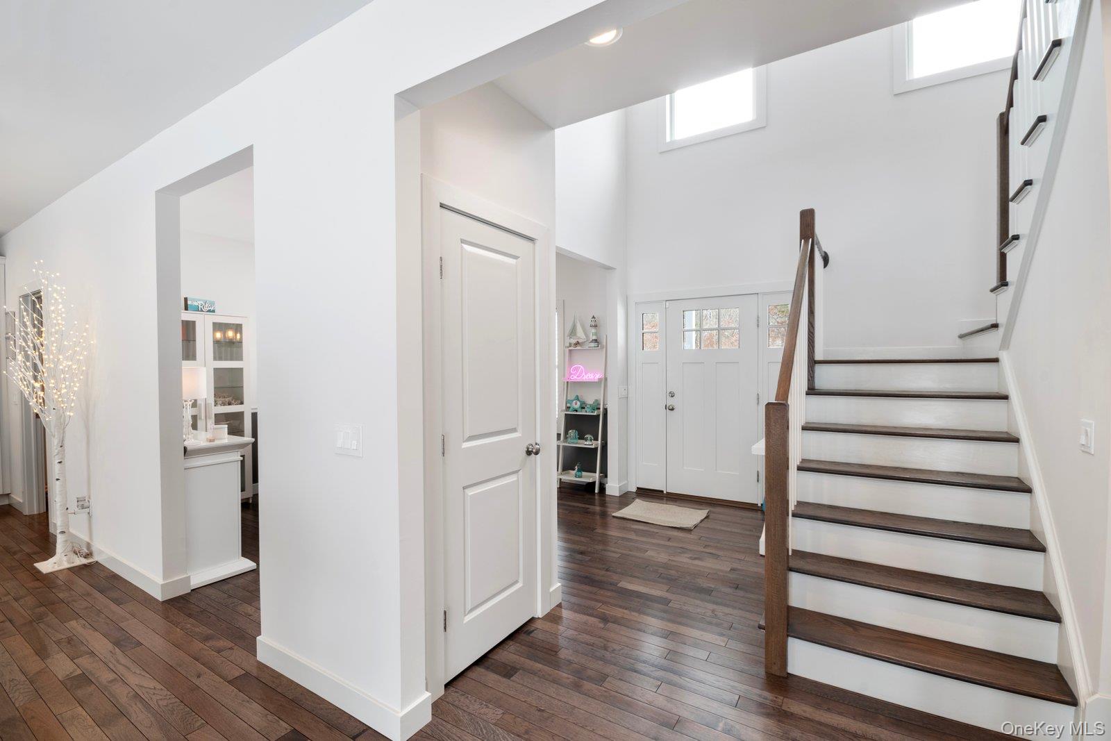 65 Doane Avenue Bellport, NY 11713 - Photo 4 of 37 a view of entryway with wooden floor and stairs