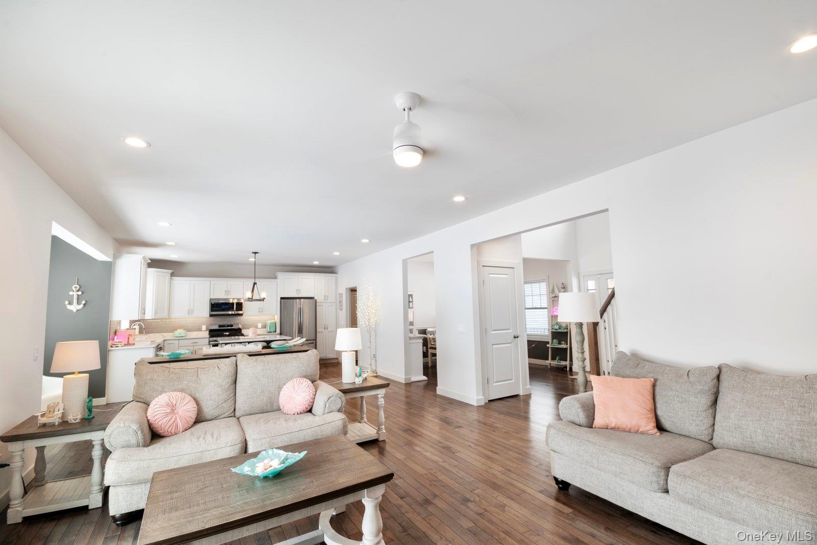 65 Doane Avenue Bellport, NY 11713 - Photo 6 of 37 a living room with furniture and kitchen view