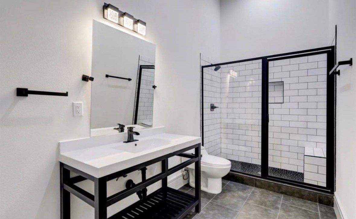 1709 Reverse Street Houston, TX 77055 - Photo 14 of 26 a bathroom with a sink a toilet and shower