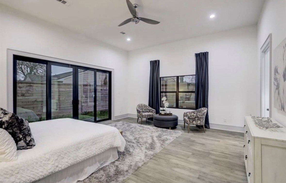 1709 Reverse Street Houston, TX 77055 - Photo 15 of 26 a bedroom with a large bed and windows