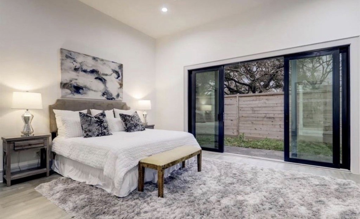 1709 Reverse Street Houston, TX 77055 - Photo 18 of 26 a bedroom with a bed and a large window
