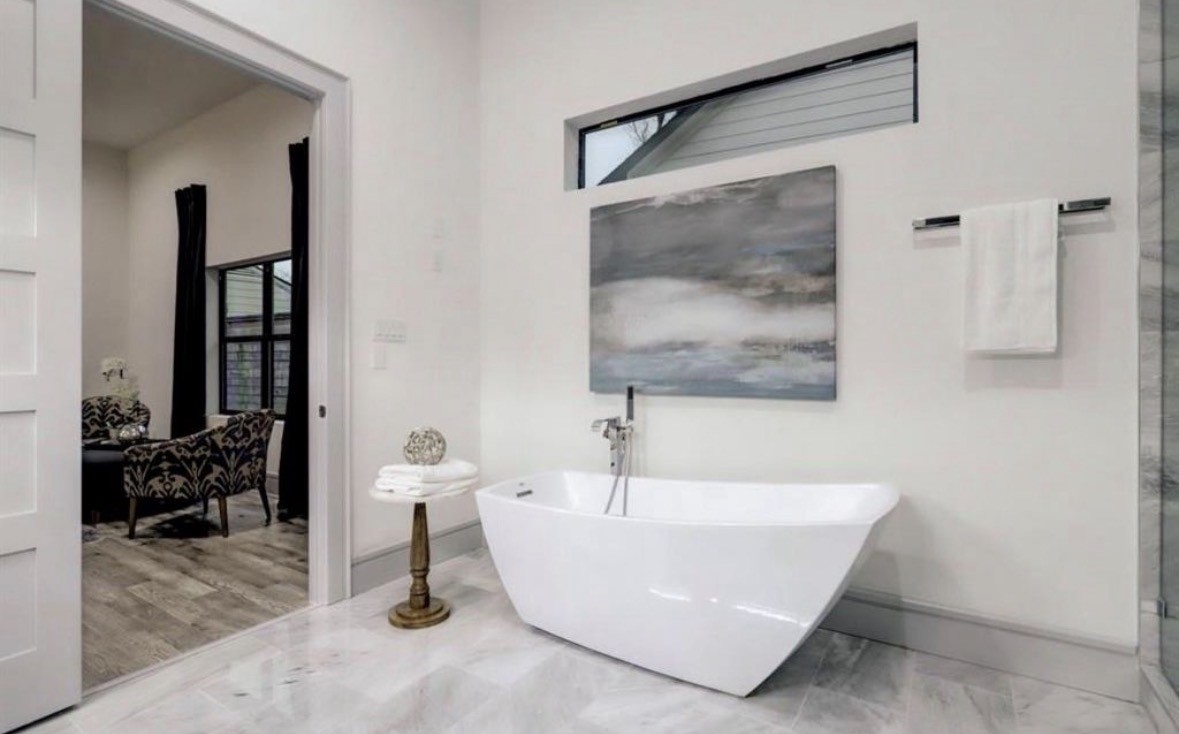 1709 Reverse Street Houston, TX 77055 - Photo 22 of 26 a white bath tub sitting next to a bathroom