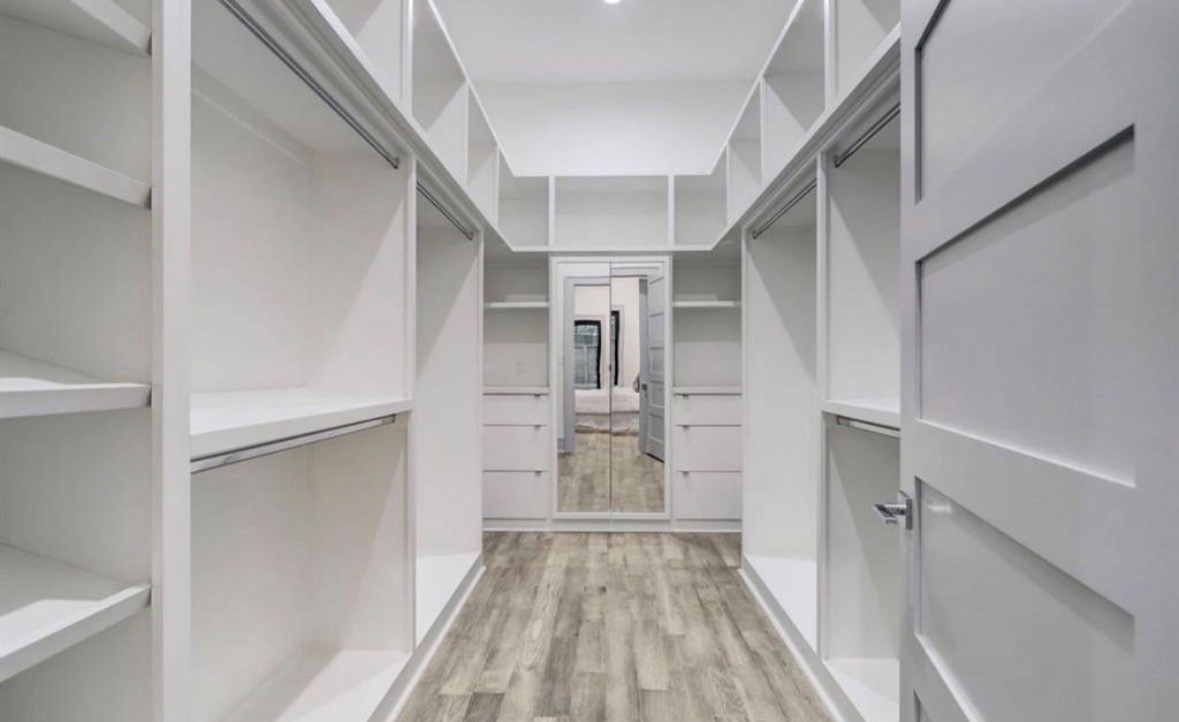 1709 Reverse Street Houston, TX 77055 - Photo 23 of 26 a view of walk in closet with wooden floor