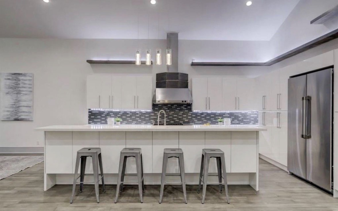 1709 Reverse Street Houston, TX 77055 - Photo 5 of 26 a kitchen with a dining table chairs cabinets and stainless steel appliances