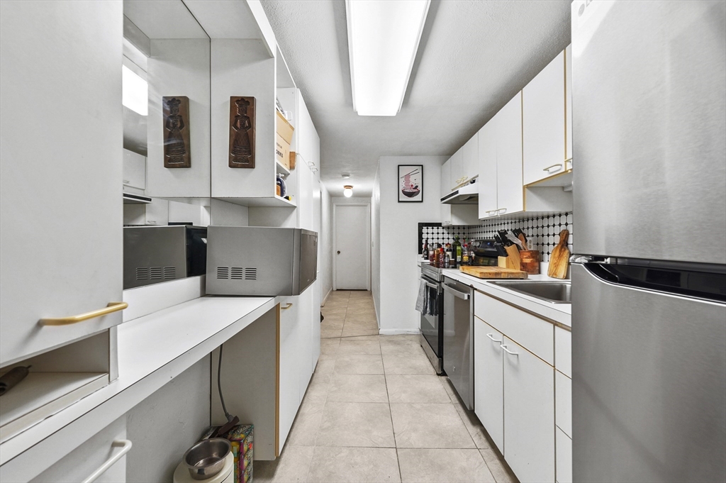 220 Swanson Road, Unit 605 Boxborough, MA 01719 - Photo 11 of 24 a kitchen with stainless steel appliances a sink and a refrigerator