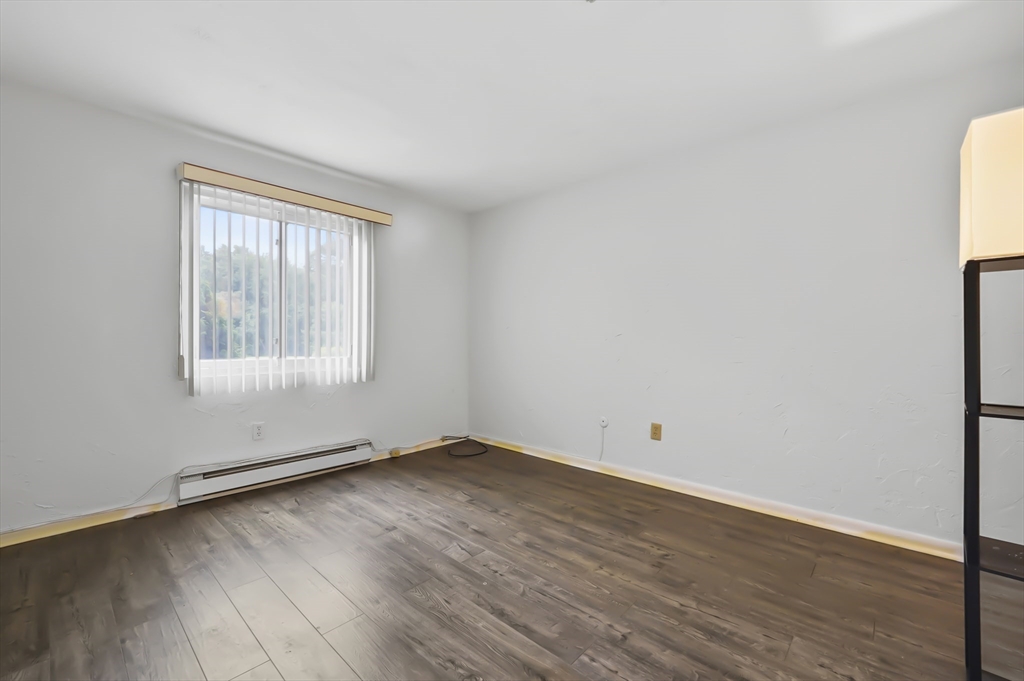 220 Swanson Road, Unit 605 Boxborough, MA 01719 - Photo 12 of 24 an empty room with wooden floor and windows