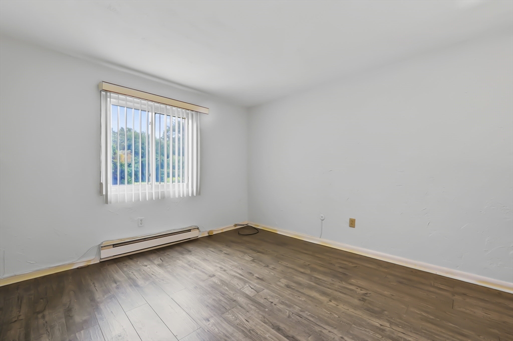 220 Swanson Road, Unit 605 Boxborough, MA 01719 - Photo 13 of 24 an empty room with wooden floor and windows