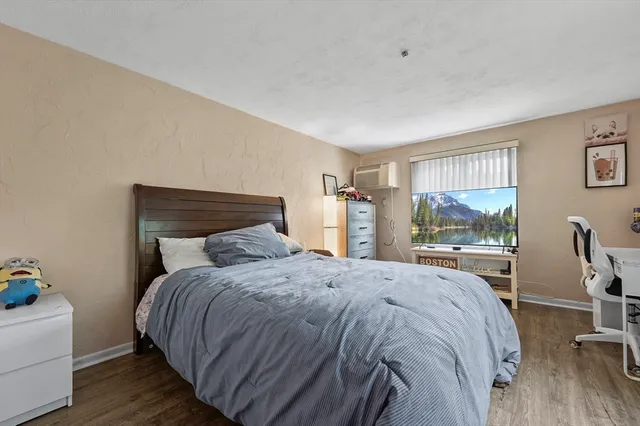 a bedroom with a bed and large windows