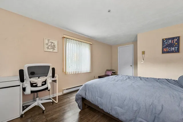 a bedroom with a bed a chair and a window