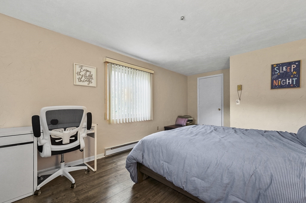 220 Swanson Road, Unit 605 Boxborough, MA 01719 - Photo 17 of 24 a bedroom with a bed a chair and a window