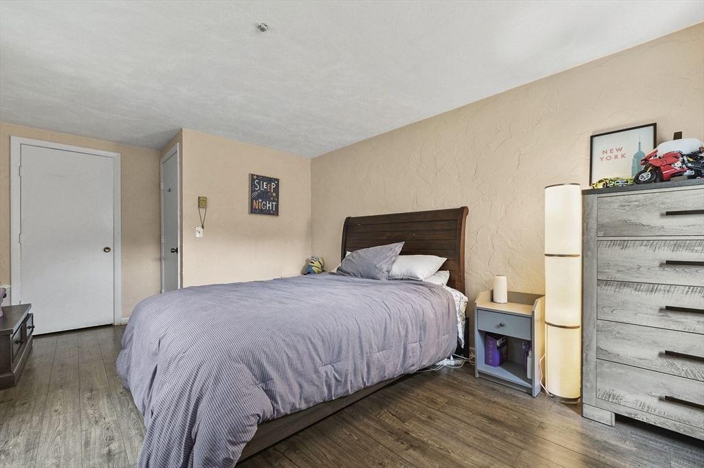 220 Swanson Road, Unit 605 Boxborough, MA 01719 - Photo 18 of 24 a bedroom with a bed and a dresser