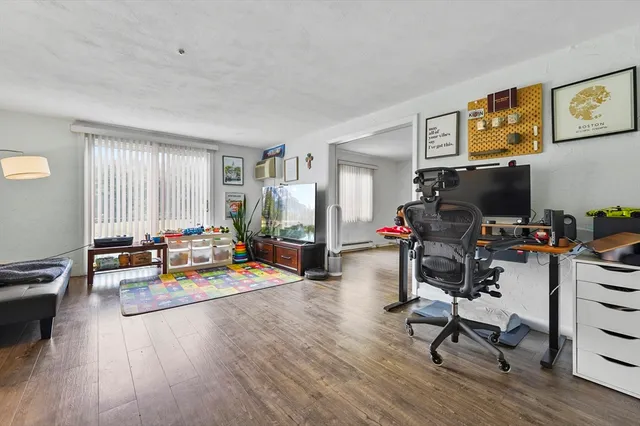 a view of a livingroom with workspace and a couch