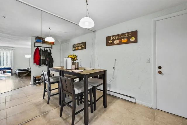 a view of a dining room with furniture and chandelier