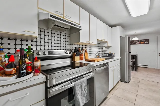a kitchen with stainless steel appliances granite countertop a sink and cabinets