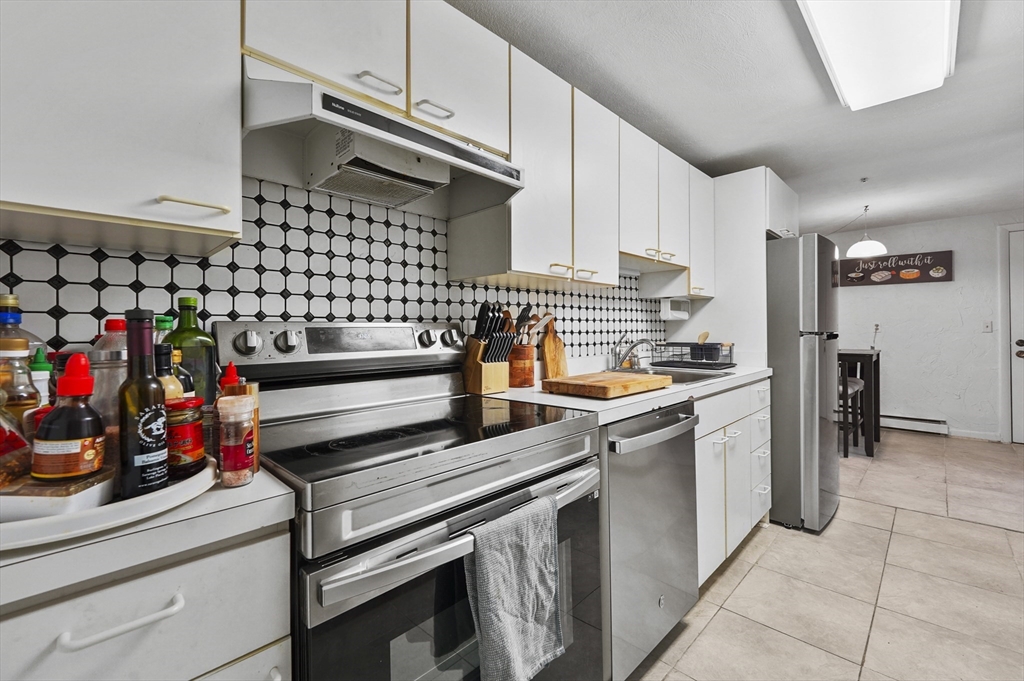 220 Swanson Road, Unit 605 Boxborough, MA 01719 - Photo 8 of 24 a kitchen with stainless steel appliances granite countertop a sink and cabinets