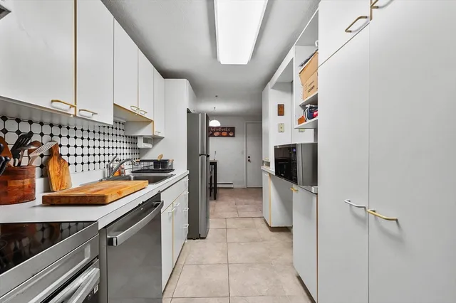 a kitchen with stainless steel appliances granite countertop a sink and cabinets