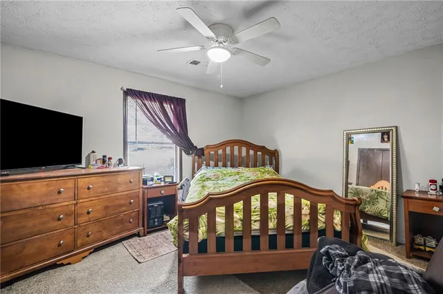a bedroom with furniture and a flat tv screen