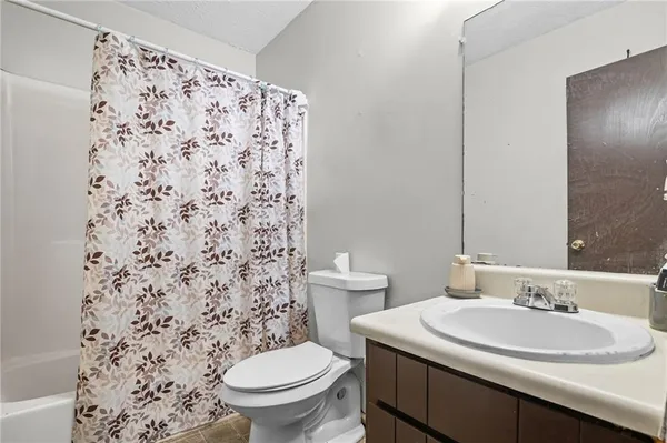 a bathroom with a sink toilet and a mirror