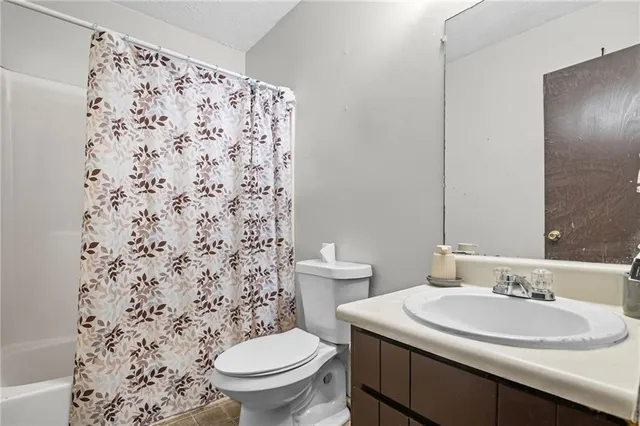 a bathroom with a sink toilet and a mirror
