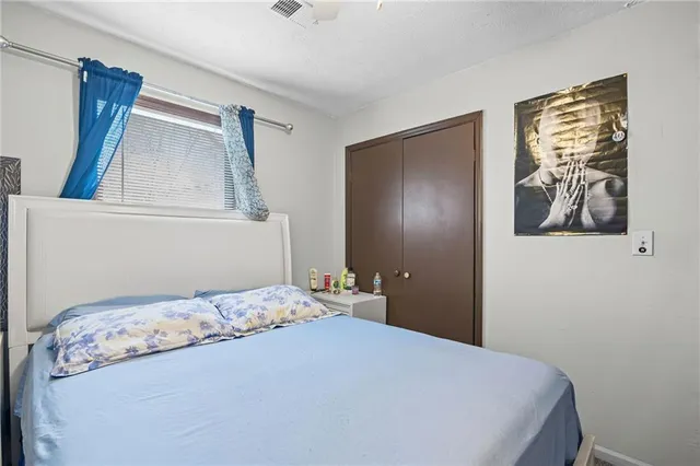 a bedroom with a bed and wall painting