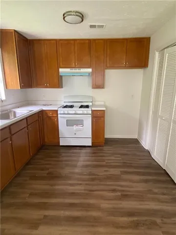 a kitchen with stainless steel appliances a stove a sink and a refrigerator