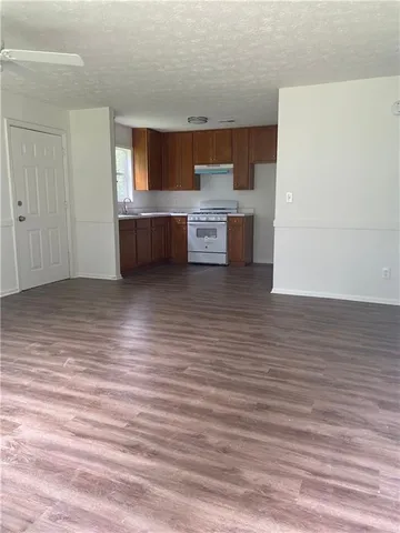 a view of a kitchen with furniture and an empty room