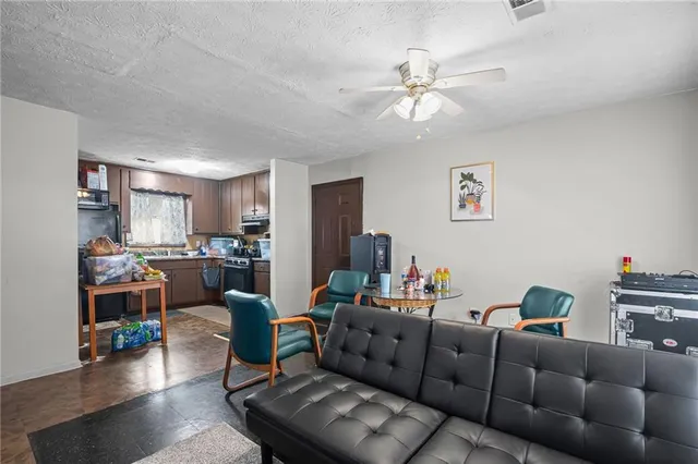 a living room with furniture and a ceiling fan
