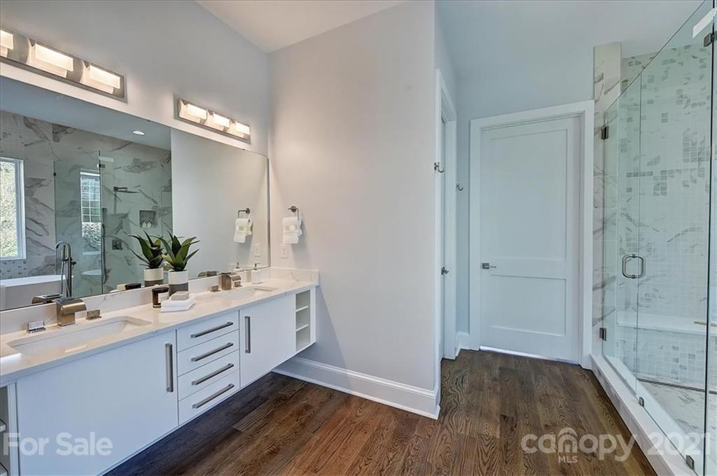 2011 Providence Road Charlotte, NC 28211 - Photo 19 of 37 a bathroom with a double vanity sink a mirror and a shower