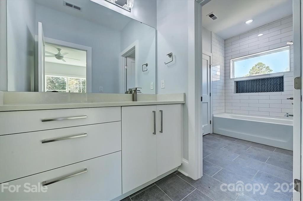 2011 Providence Road Charlotte, NC 28211 - Photo 29 of 37 a bathroom with a shower sink and mirror
