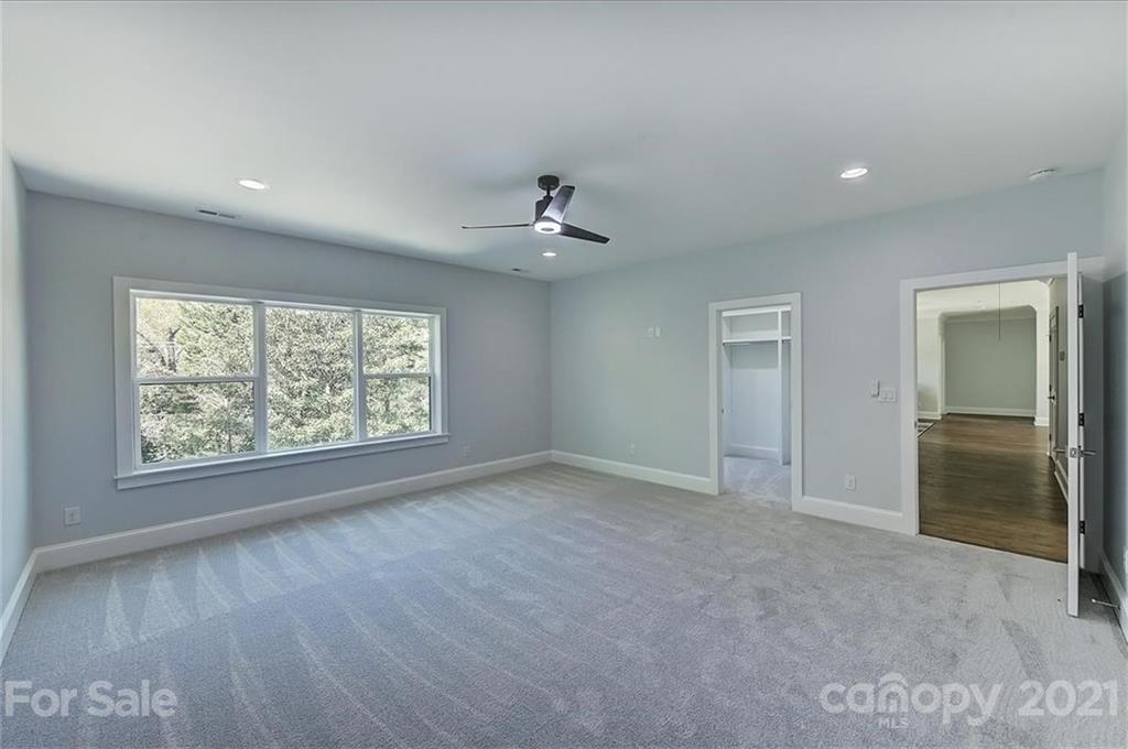 2011 Providence Road Charlotte, NC 28211 - Photo 32 of 37 an empty room with windows and a ceiling fan