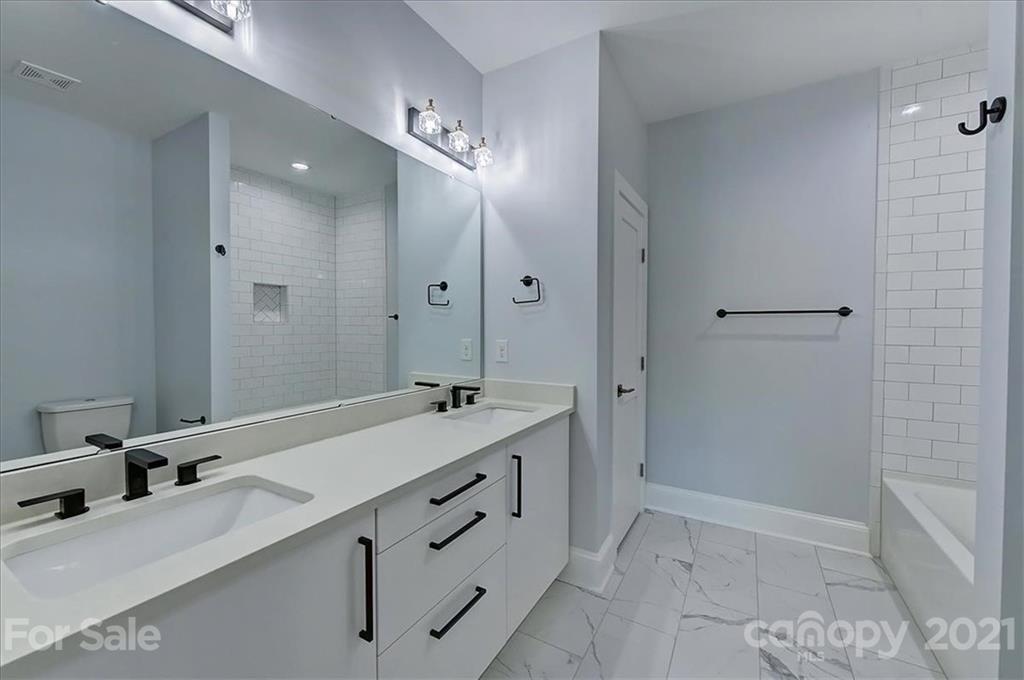 2011 Providence Road Charlotte, NC 28211 - Photo 33 of 37 a bathroom with a double vanity sink and mirror