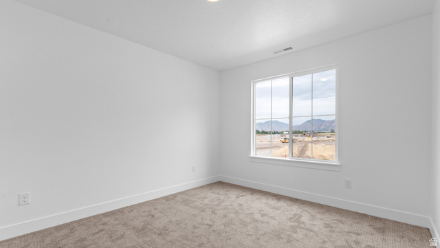 4170 North 560th West, Unit 6 Tooele, UT 84074 - Photo 18 of 20 Bright room with a large window, plush carpet, white walls, and white trim