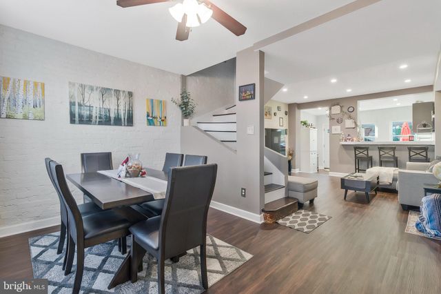a view of a dining room with furniture wooden floor and a chandelier