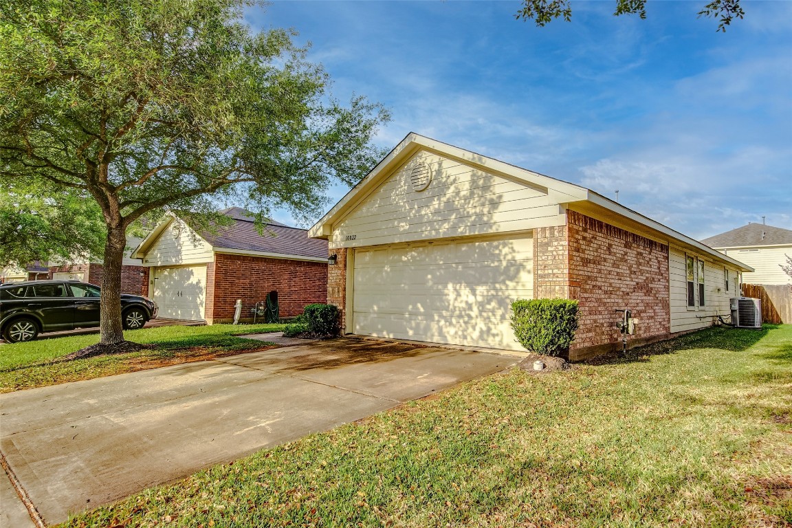 a view of a house with a yard and garage