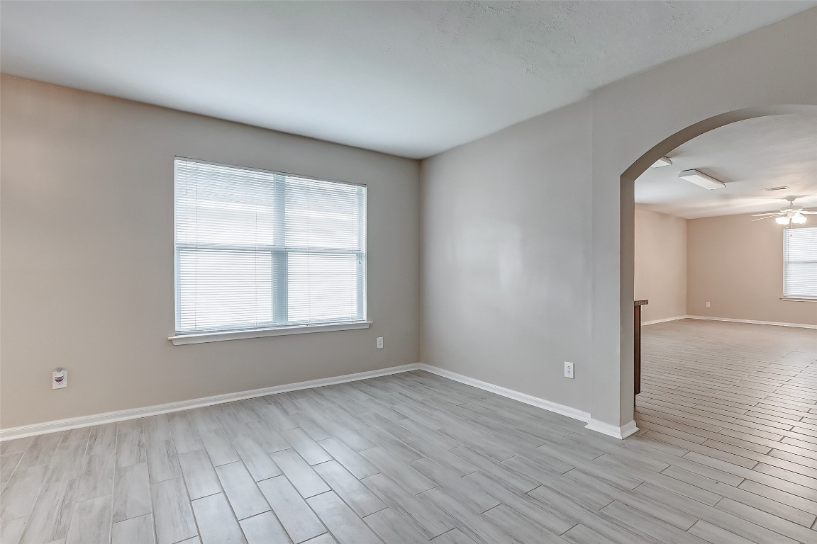 10822 Cane Grove Lane Houston, TX 77075 - Photo 12 of 44 an empty room with wooden floor and windows