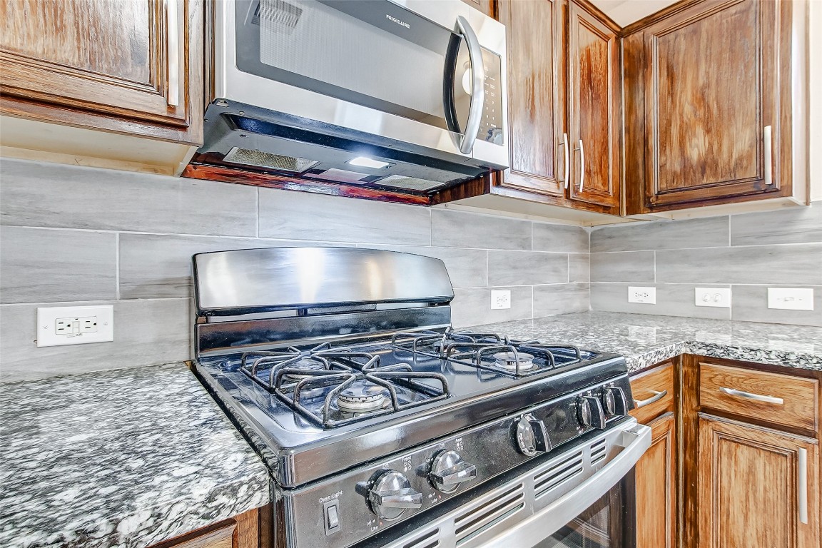 10822 Cane Grove Lane Houston, TX 77075 - Photo 22 of 44 a stove top oven sitting inside of a kitchen
