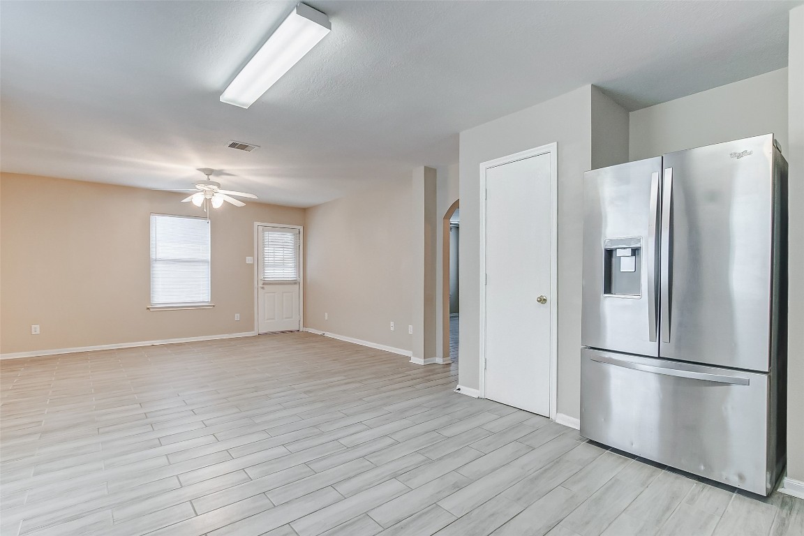 10822 Cane Grove Lane Houston, TX 77075 - Photo 23 of 44 a view of a kitchen with a refrigerator and wooden floor