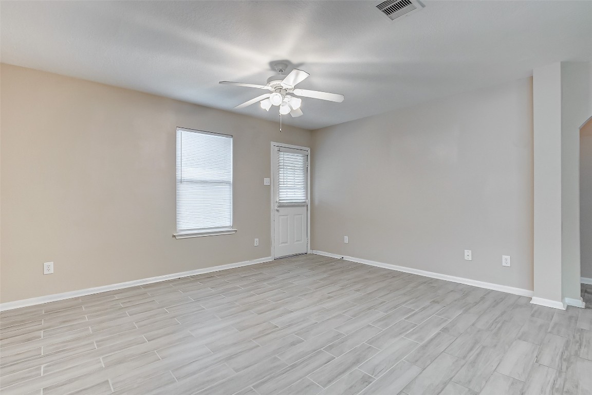 10822 Cane Grove Lane Houston, TX 77075 - Photo 30 of 44 an empty room with wooden floor fan and windows