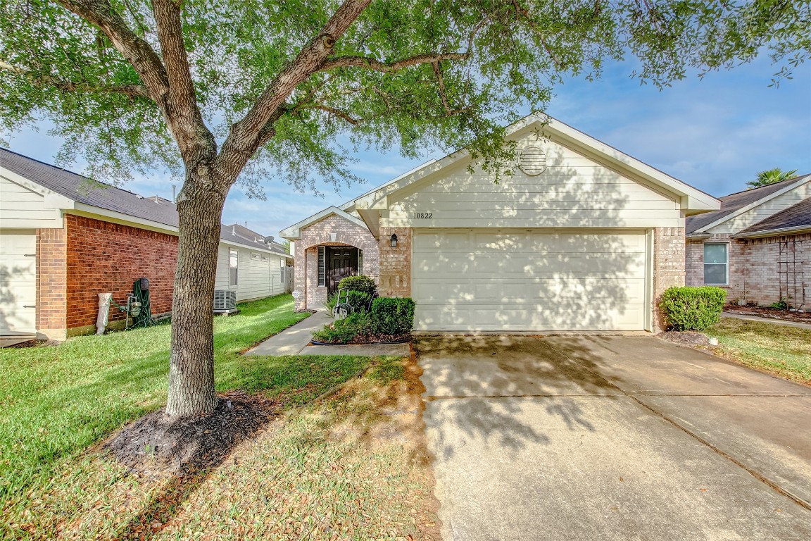 10822 Cane Grove Lane Houston, TX 77075 - Photo 3 of 44 a front view of a house with a yard and garage