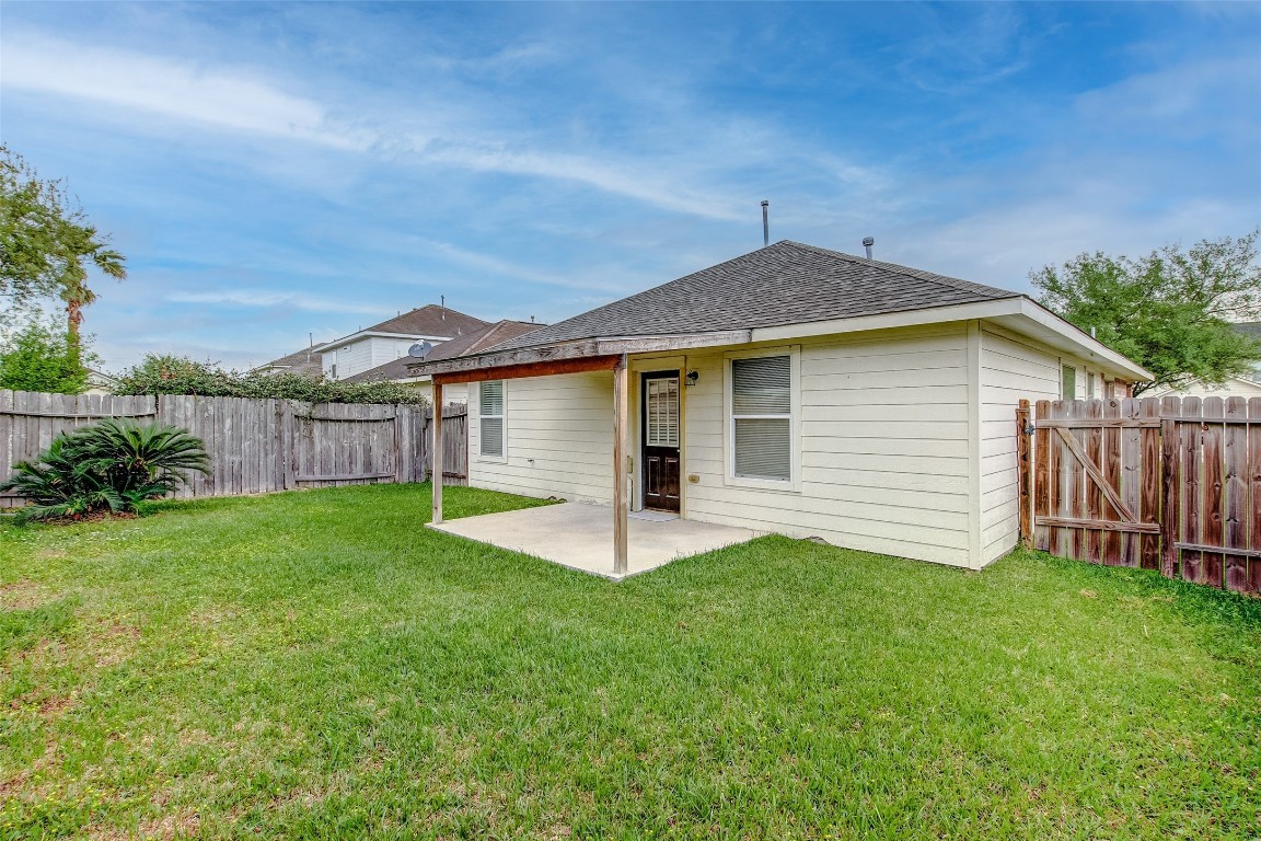 10822 Cane Grove Lane Houston, TX 77075 - Photo 41 of 44 a view of a house with a yard and deck