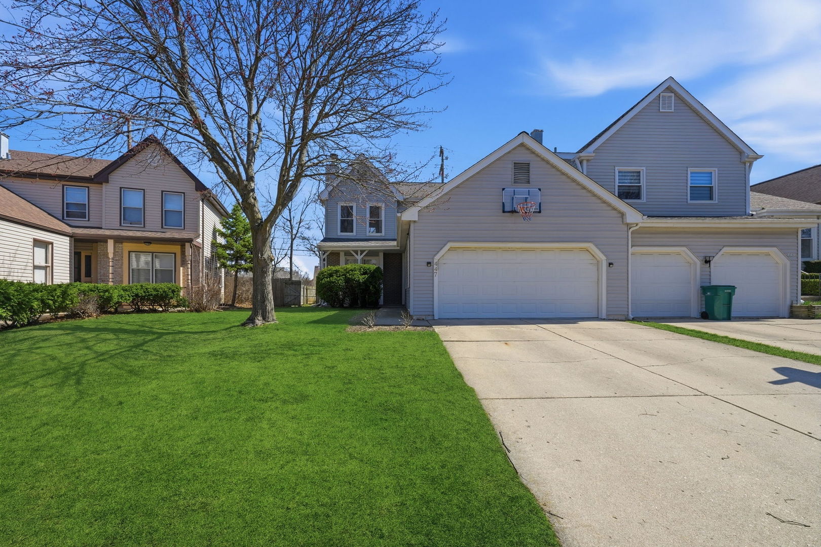 447 Thorndale Court Buffalo Grove, IL 60089 - Photo 1 of 24 a front view of a house with a yard and garage