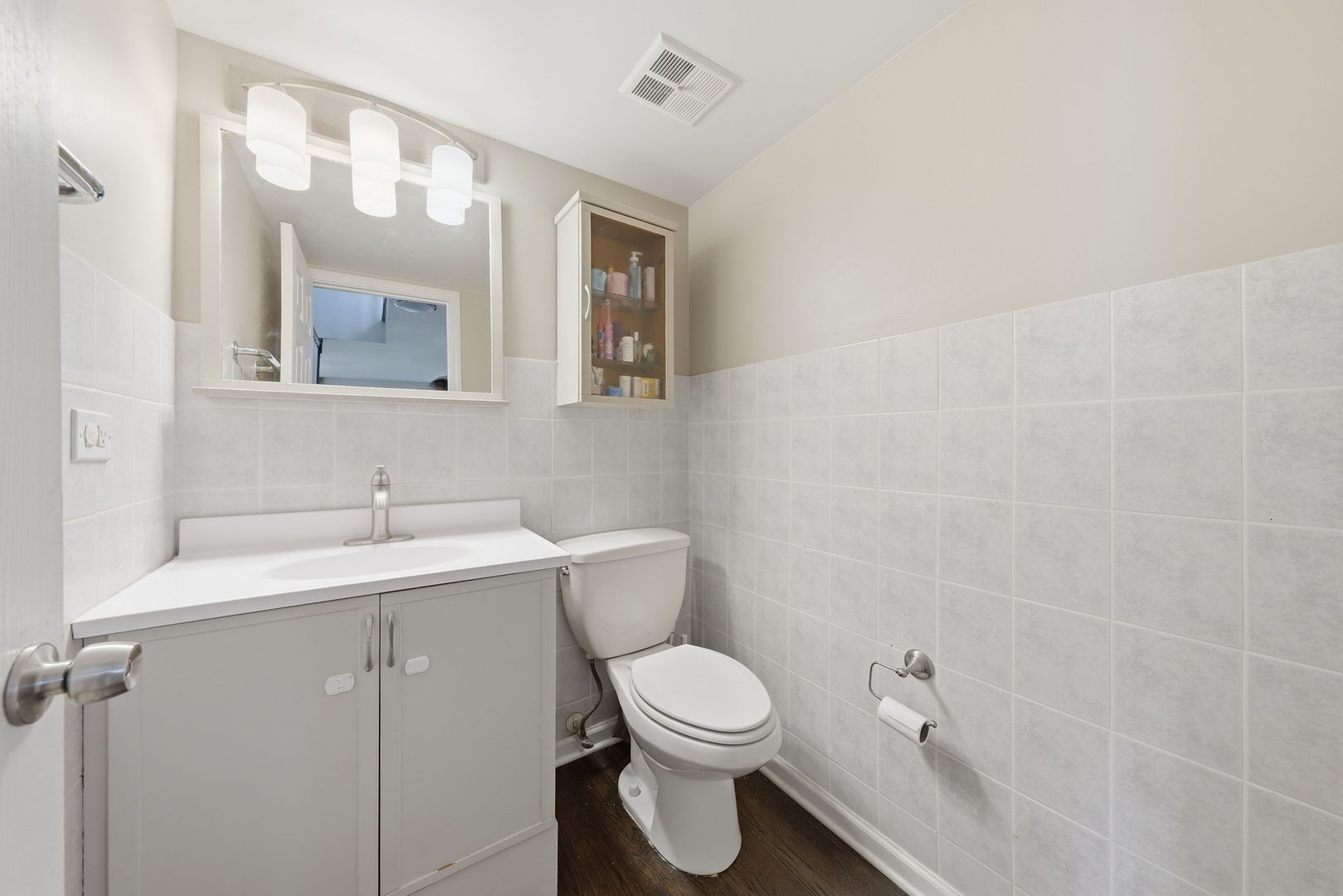 447 Thorndale Court Buffalo Grove, IL 60089 - Photo 12 of 24 a bathroom with a toilet a sink and mirror