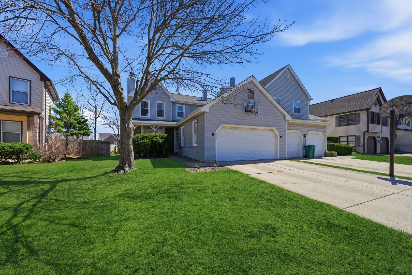 447 Thorndale Court Buffalo Grove, IL 60089 - Photo 2 of 24 a front view of a house with a yard and garage