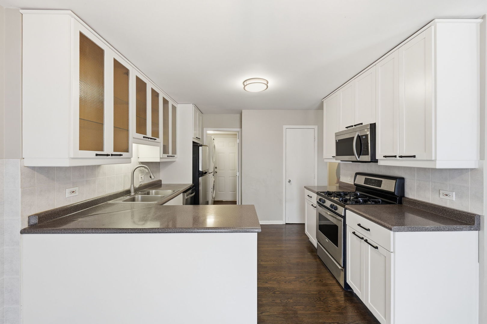 447 Thorndale Court Buffalo Grove, IL 60089 - Photo 5 of 24 a kitchen with stainless steel appliances granite countertop a stove a sink and a microwave