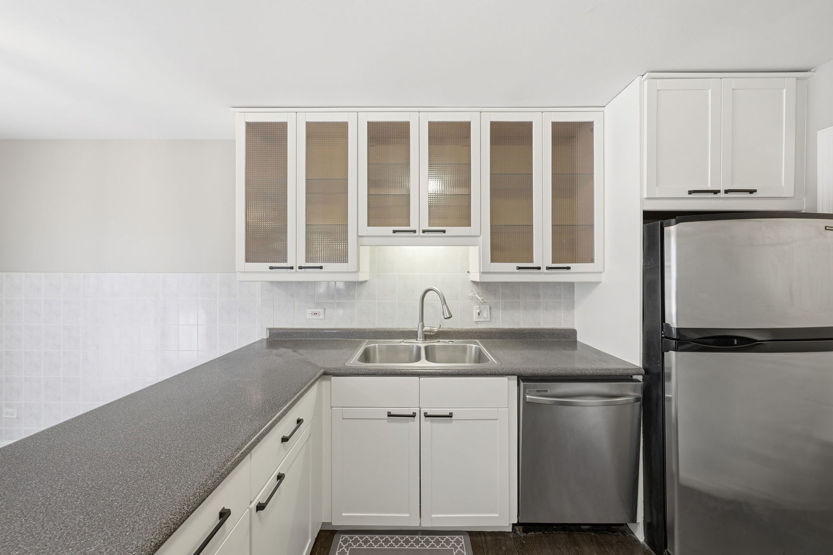 447 Thorndale Court Buffalo Grove, IL 60089 - Photo 7 of 24 a kitchen with a sink and a refrigerator