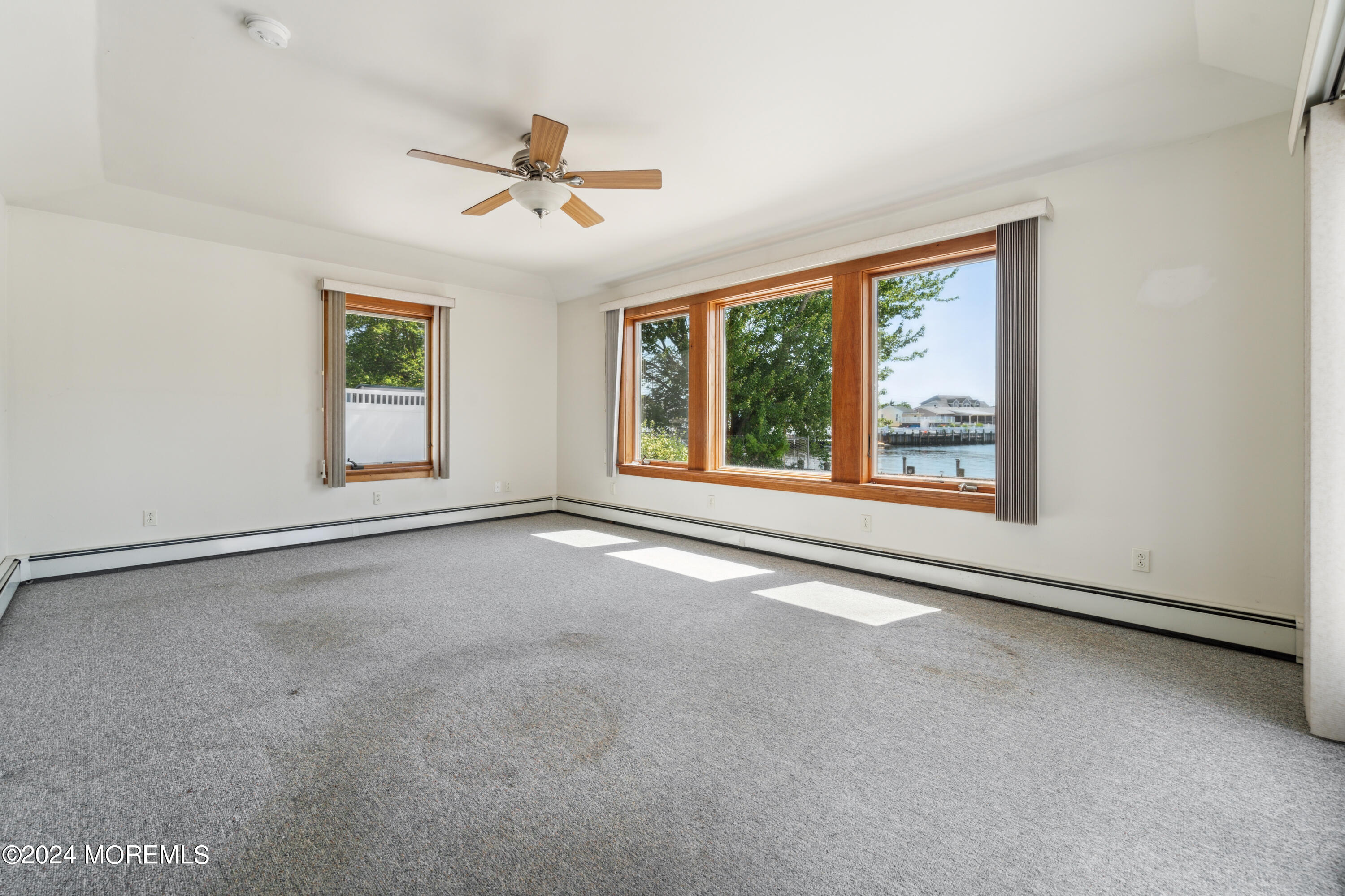 232 11th Street Barnegat, NJ 08005 - Photo 12 of 39 an empty room with windows and ceiling fan