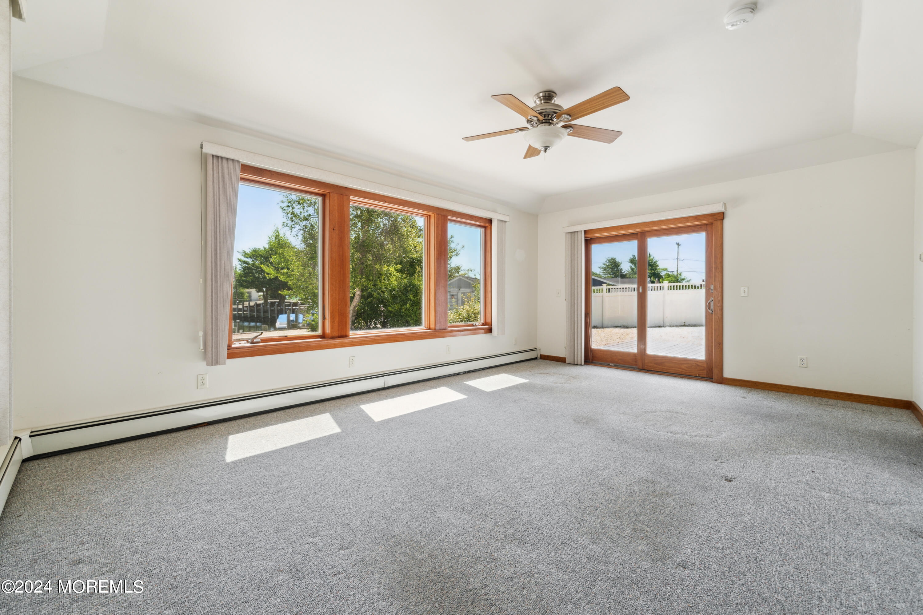 232 11th Street Barnegat, NJ 08005 - Photo 13 of 39 a view of a livingroom with a ceiling fan and window