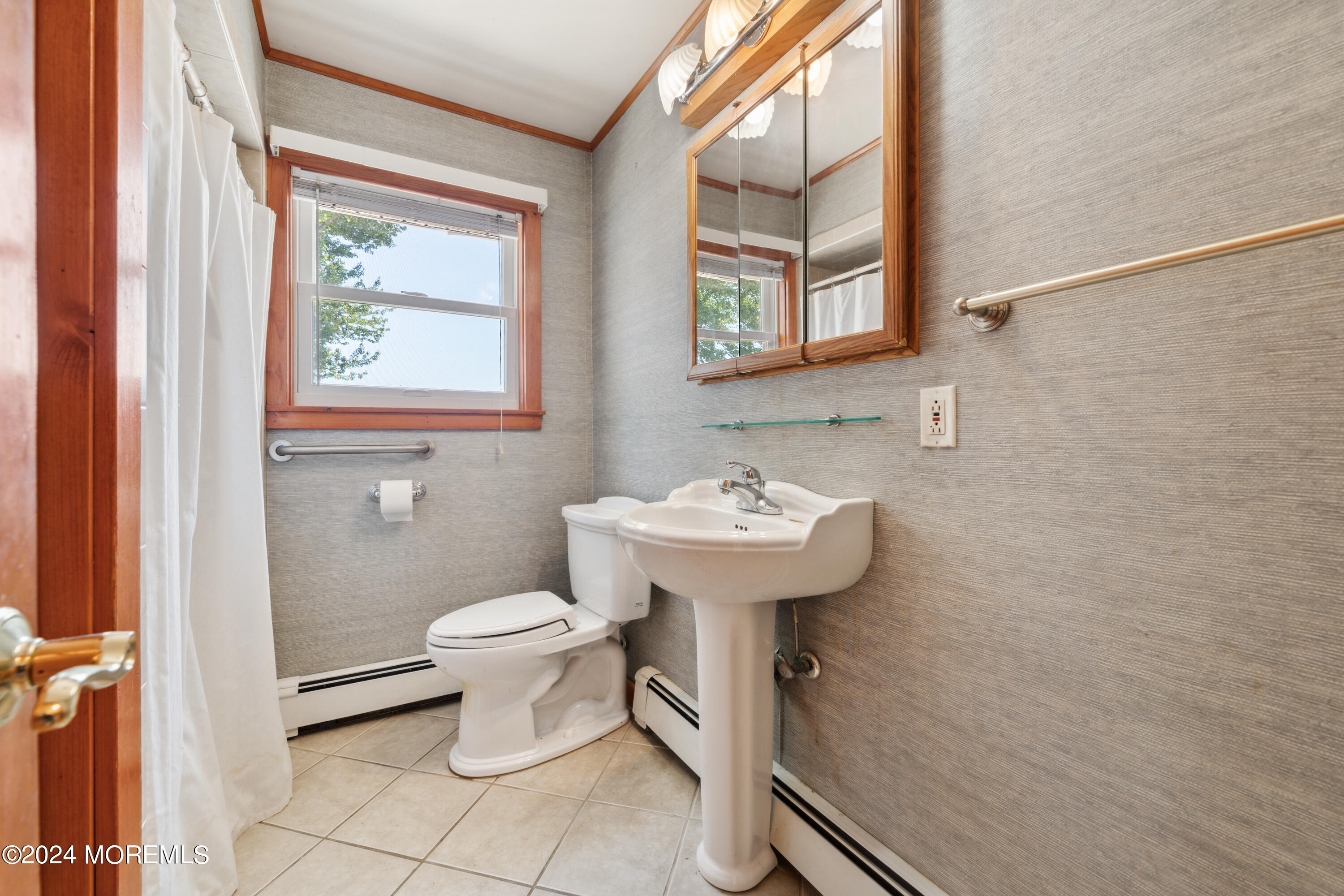 232 11th Street Barnegat, NJ 08005 - Photo 16 of 39 a bathroom with a toilet sink and mirror