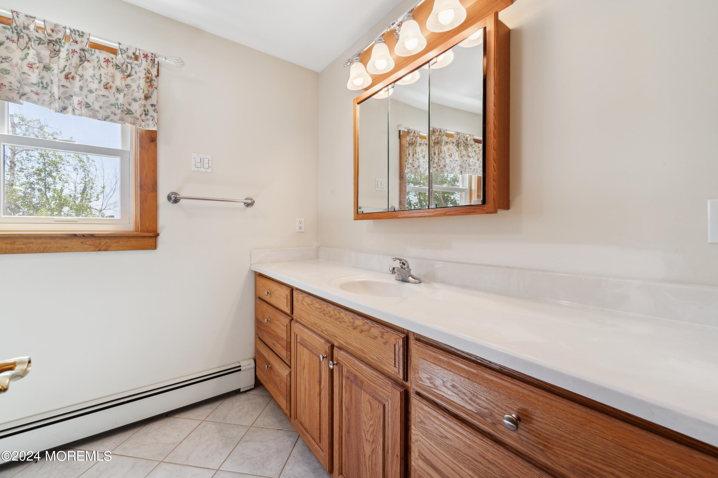 232 11th Street Barnegat, NJ 08005 - Photo 19 of 39 a bathroom with a sink and a window